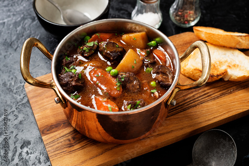 Irish stew made with beef, potatoes, carrots and herbs. Traditional St patrick's day dish. Black background.