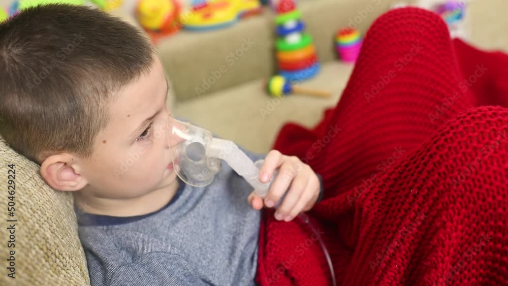 child teenager boy breathes through an inhaler or nebulizer child teenager boy breathes through an inhaler or nebulizer