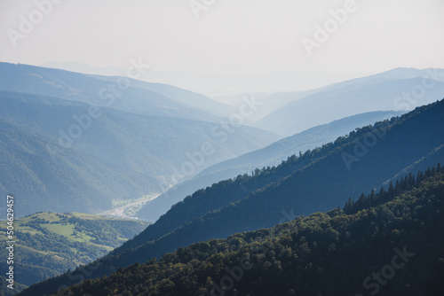 Amazing landscape in summer. Light and afternoon shadow over scenic mountain hills  clear blue sky. Mountain valley.
