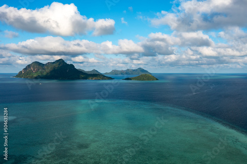 Drone point of view of tropical island Maiga near Tun Sakaran Marine Park