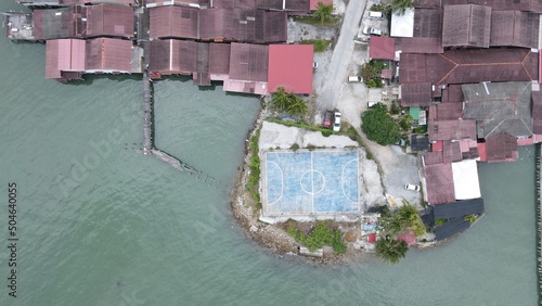 Georgetown, Penang Malaysia - May 13, 2022: The Clan Jetties of Georgetown Penang, Malaysia. Wooden villages built on stilts at the sea coast by the different clans of the Penang Chinese community. photo