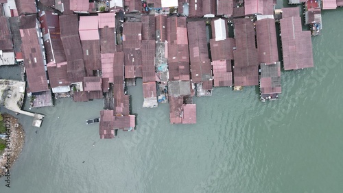 Georgetown, Penang Malaysia - May 13, 2022: The Clan Jetties of Georgetown Penang, Malaysia. Wooden villages built on stilts at the sea coast by the different clans of the Penang Chinese community. photo