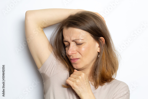 Unpleasant smell from sweat under the arm of a woman.