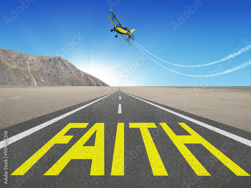 The word Faith written on a road of a spiritual journey.