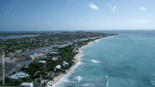 Drone camera flies toward coastal area of Cockburn Town, Grand Turk, Turks and Caicos, aerial footage from tropical island
 photo