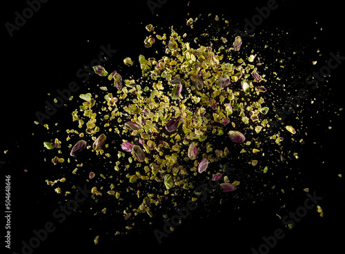 Crushed and whole kernels raw pistachio explosion photo
