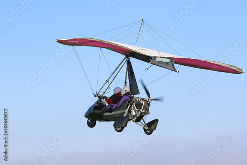 Canvas-taulu Ultralight airplane flying in a blue sky