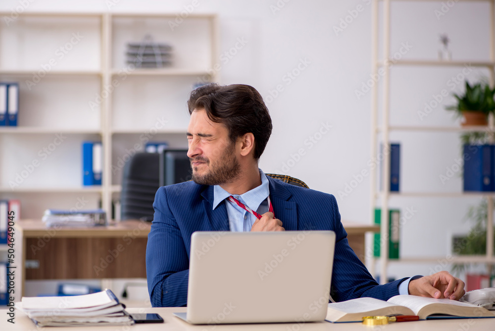 Young male employee working in the office Young male employee working in the office