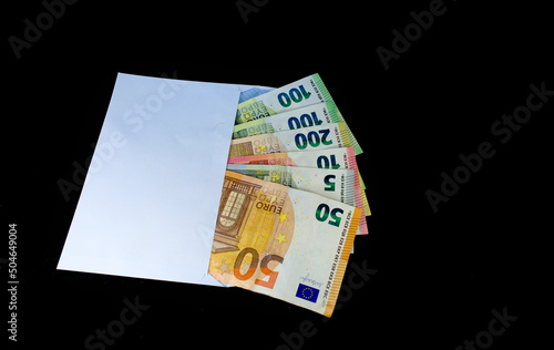 Euro in a white envelope on a black background. The concept of the "shadow" market