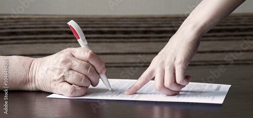 Canvas-taulu An old woman is forced to write a will for an apartment