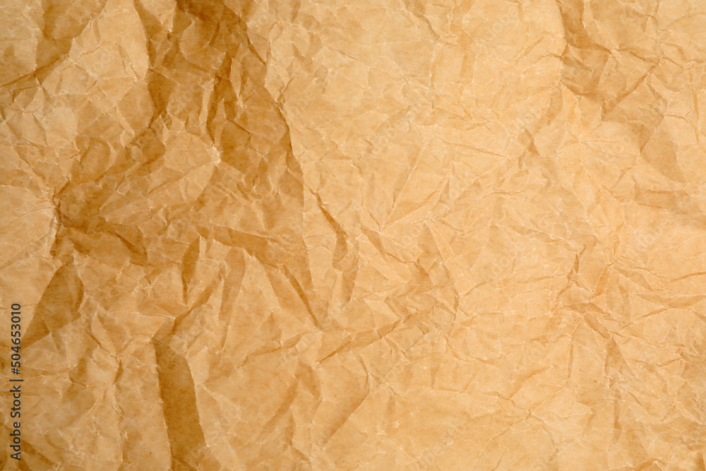Obraz premium Texture of crumpled brown baking paper as background, closeup