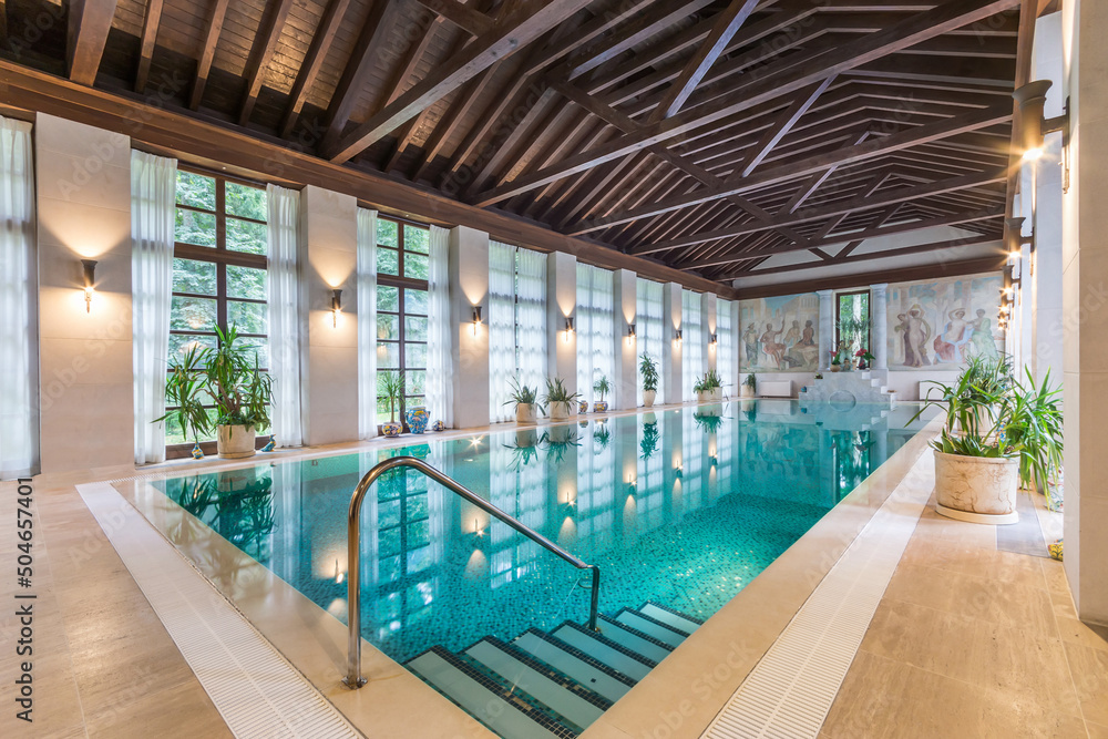 Spacious room of a private house with large windows and a swimming pool. Spacious room of a private house with large windows and a swimming pool.