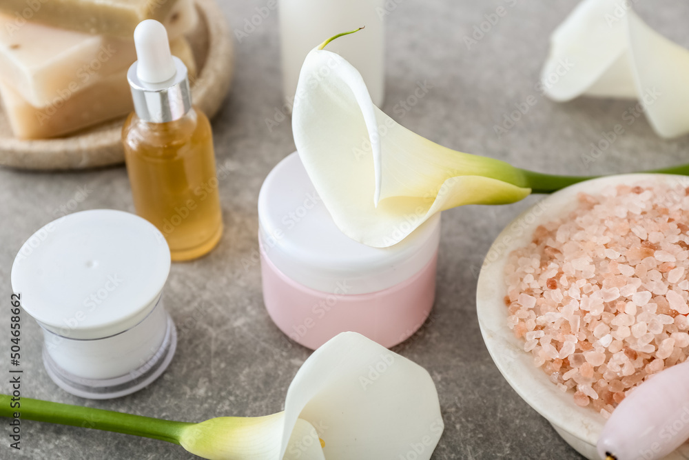 Cosmetic products, sea salt and calla lilies on table, closeup Cosmetic products, sea salt and calla lilies on table, closeup