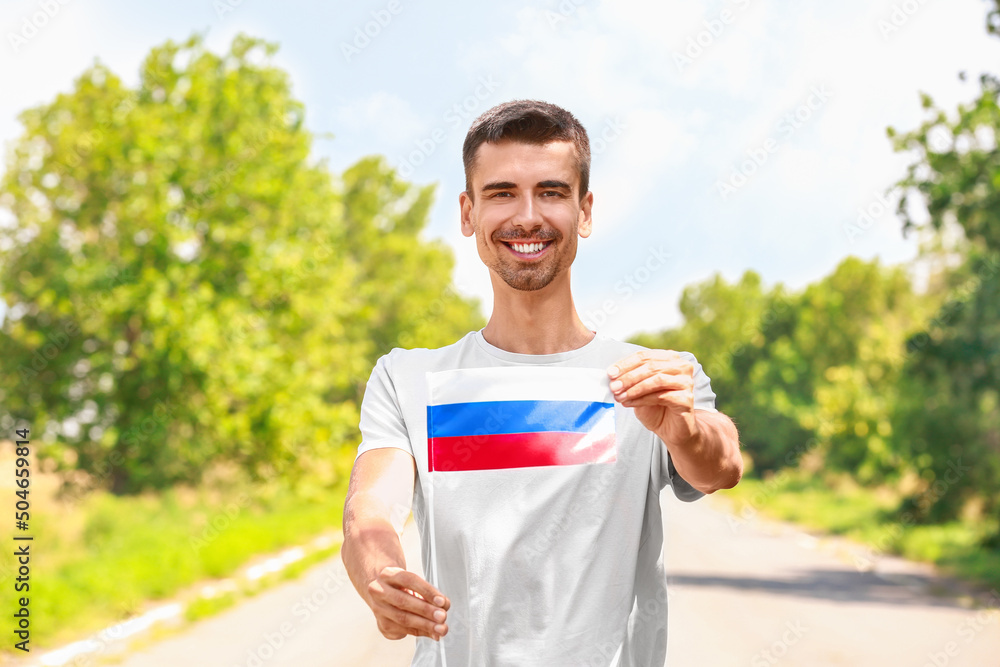 Happy young man with national flag of Russia outdoors Happy young man with national flag of Russia outdoors
