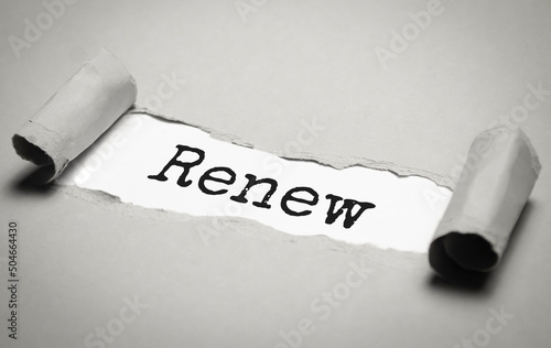 The text renew appearing behind torn brown paper. business concept