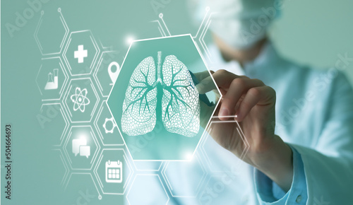 Unrecognizable female doctor holding graphic virtual visualization model of Lungs organ in hands. Multiple virtual medical icons.