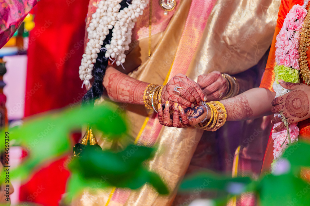 Indian Hindu wedding ceremony and rituals bride and groom's hands close up