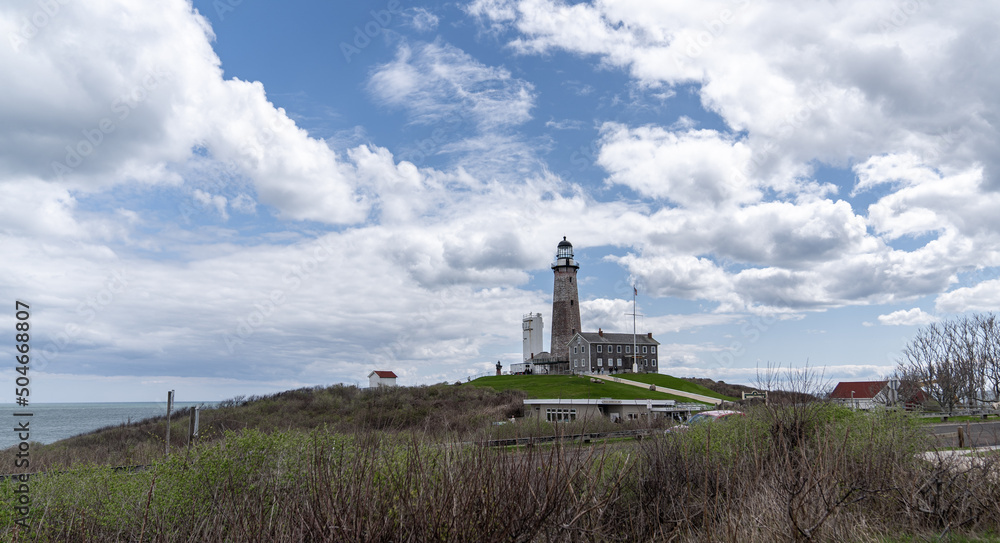 Lighthouse on a blue day with white clouds