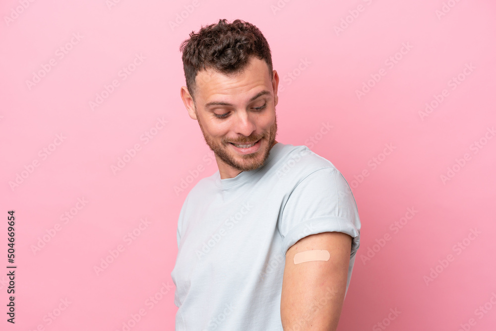 Young Brazilian man wearing a band-aids isolated on pink background with happy expression Young Brazilian man wearing a band-aids isolated on pink background with happy expression