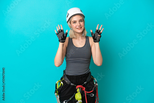 Young caucasian rock-climber woman isolated on white background counting nine with fingers photo