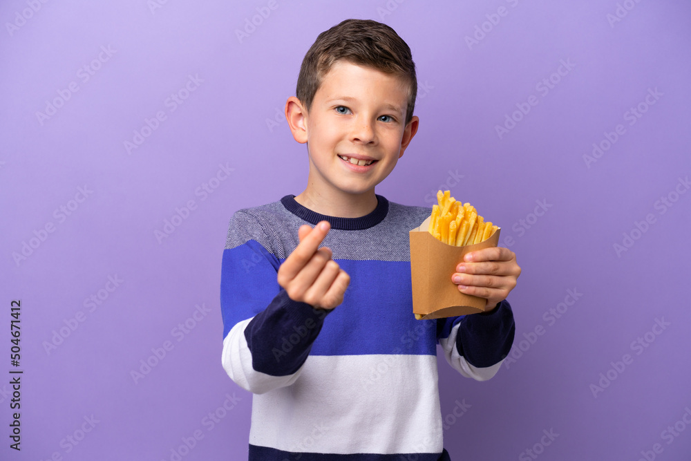 Little boy holding fried chips isolated on purple background making money gesture Little boy holding fried chips isolated on purple background making money gesture