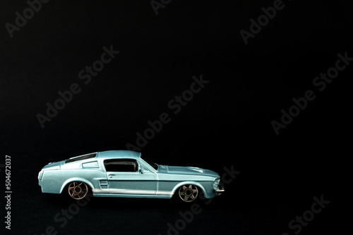 Old school classy composition  with metallic blue oldtimer. Classy  vintage concept on black background.