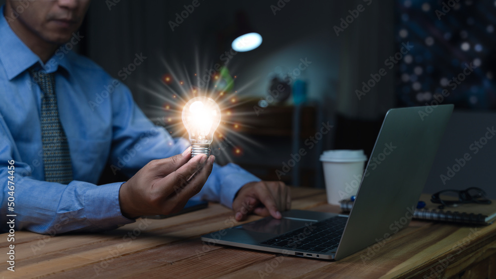 Businessman holding illuminated lightbulb, idea, Innovation and inspiration with glowing virtual brain, smart intelligent creativity with bulbs, Motivation and innovation concept.