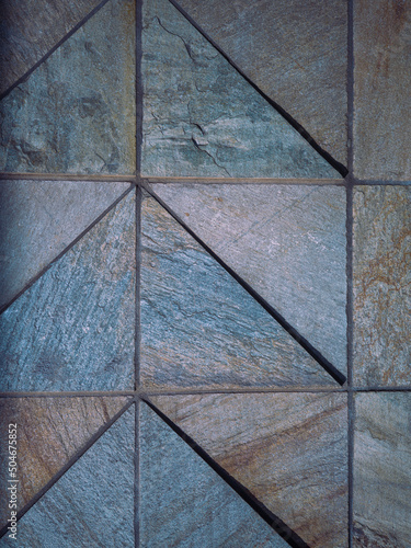 Slate Tiled Wall with Upward Pattern of Arrows.