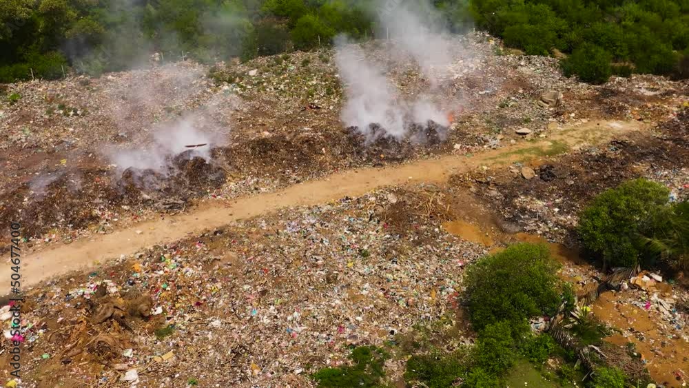 Birds over a burning pile of garbage. Landfill in Sri Lanka. Birds over a burning pile of garbage. Landfill in Sri Lanka.
