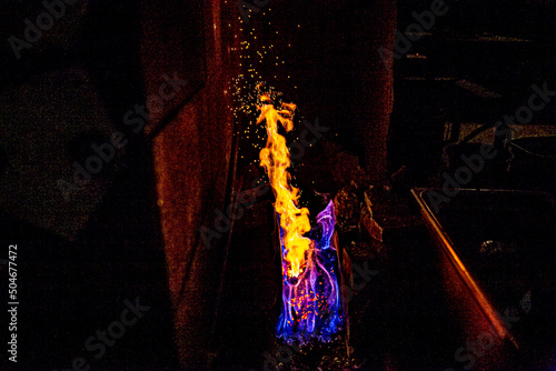 Fire and coal forging Japanese sword in a kiln of a blacksmith in Japan.