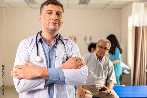 Male doctor with stethoscope standing with arms folded Looking at the camera On the background of the clinic hospital look ta camera.