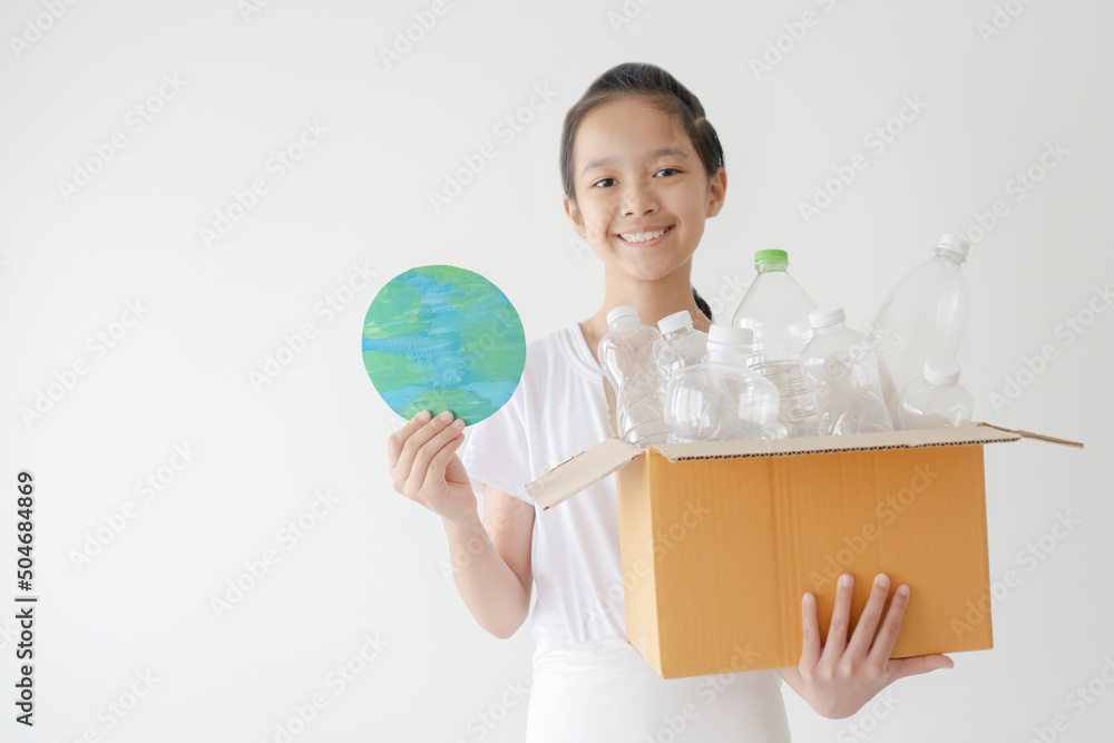 Asian school girl with a concept of recycle plastic bottles. Happy smiling kid carrying empty used recycling bottles. Little eco-activist student learned the environment protection. Asian school girl with a concept of recycle plastic bottles. Happy smiling kid carrying empty used recycling bottles. Little eco-activist student learned the environment protection.
