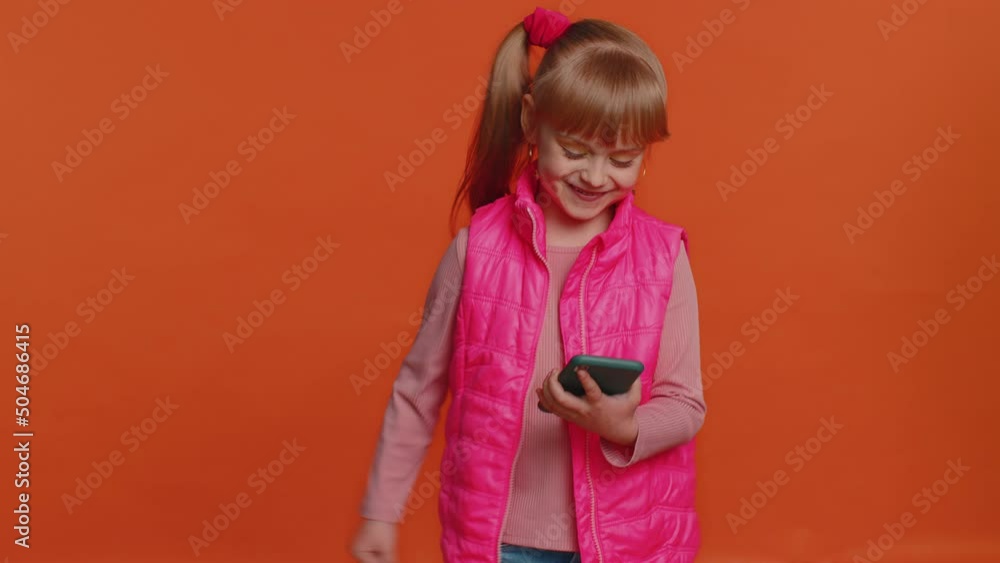 Happy excited joyful girl in pink blouse, vest use mobile cell phone typing browsing shouting say wow yes found out great big win, good news, lottery goal achievemen, celebrating success, winning Happy excited joyful girl in pink blouse, vest use mobile cell phone typing browsing shouting say wow yes found out great big win, good news, lottery goal achievemen, celebrating success, winning