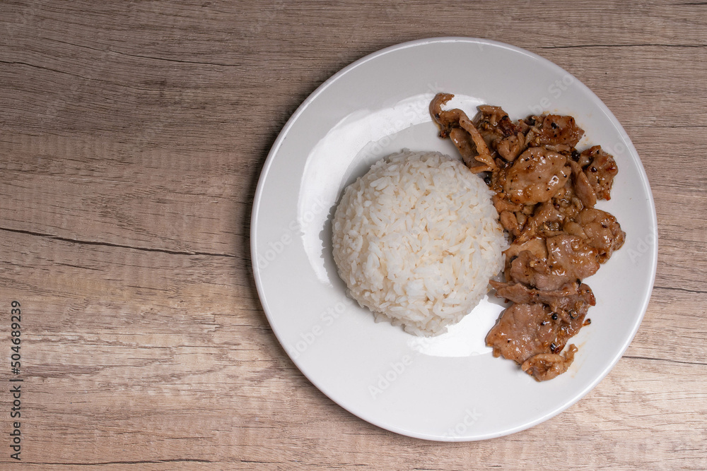 Fried pork with garlic and pepper in a white plate Fried pork with garlic and pepper in a white plate
