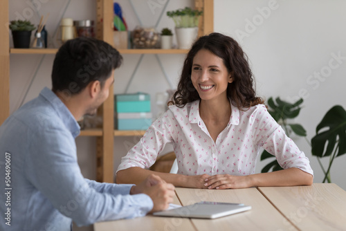 Happy adult students, interns discussing class project at table, chatting, laughing, Corporate coworkers, recruit agent, HR manager and hob candidate meeting in office for interview, talking photo