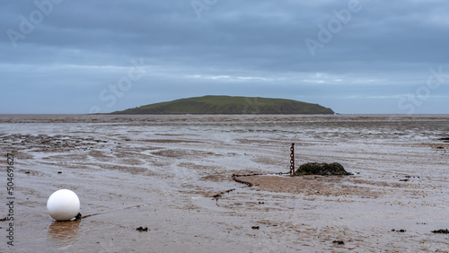 Low tide over Balcary Bay with Heston Island and Balcary Tower in the background photo
