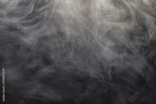 Bizarre swirls of gray smoke creeping in the dark. Clouds of gray smoke.