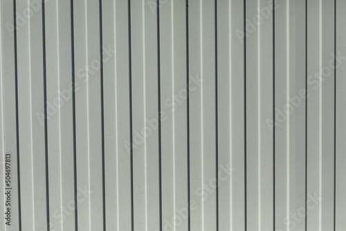 Steel fence. Metal profile sheet of white color.