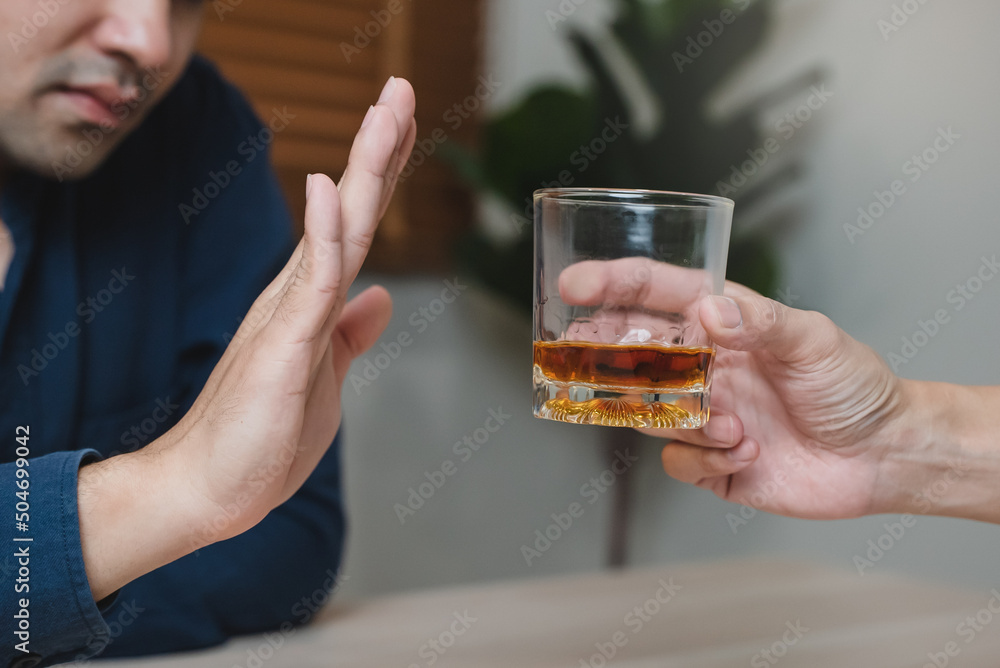 person deny alcohol drink from his friend person deny alcohol drink from his friend