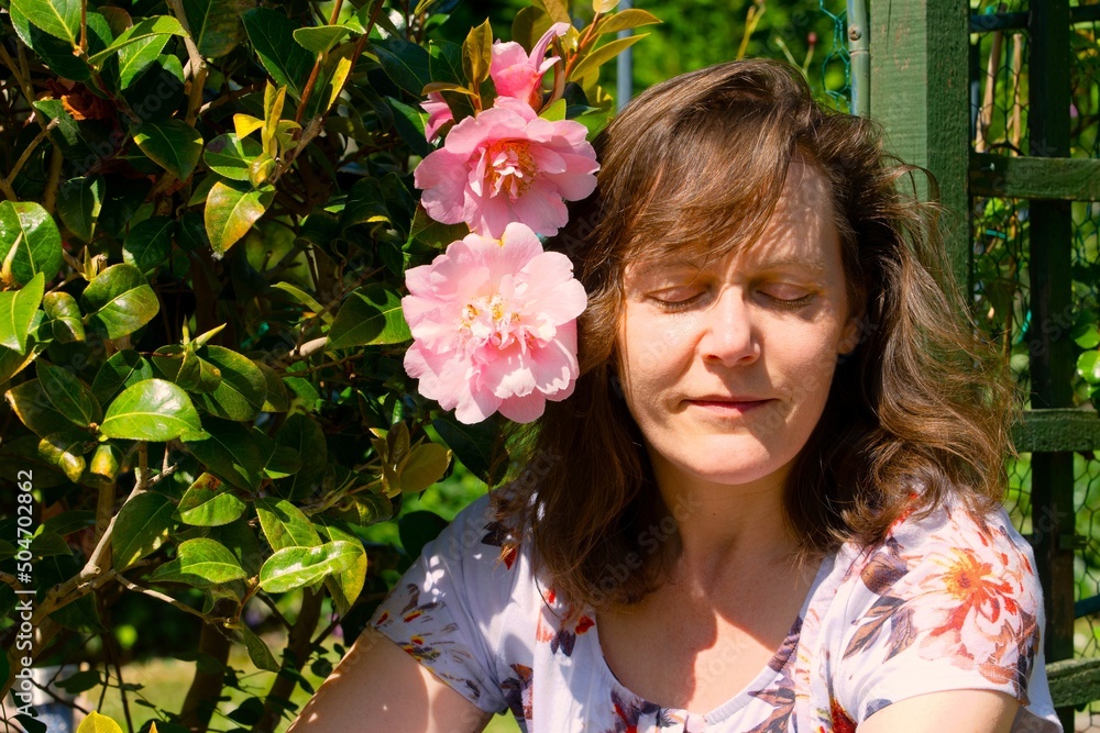 Fototapeta premium Girl with pink flowers, meditating.