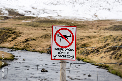 Grundarfjordur, Iceland, May 6, 2022: sign near Kirkjufellfoss waterfall banning the use of drones for aerial photography photo