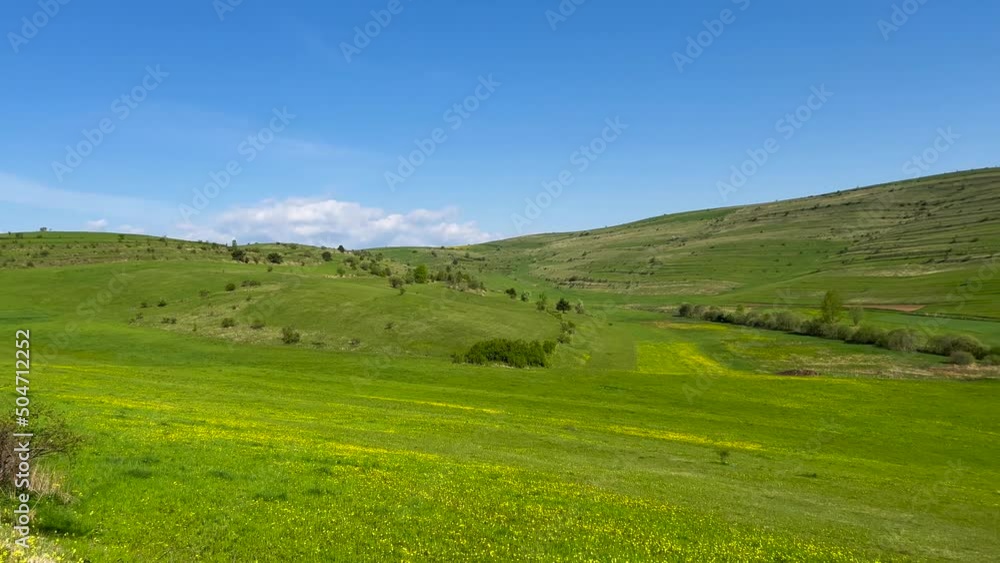 Slow panoramic shot, beautiful green valley at springtime in Transylvania, Romania.