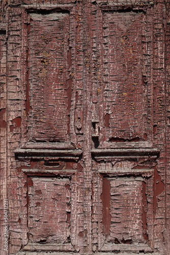 An abandoned, peeling, old-fashioned door.
