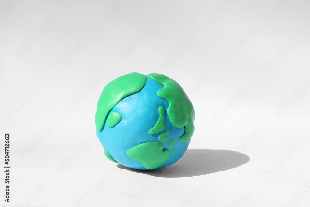Planet Earth model made of colorful plasticine on white background