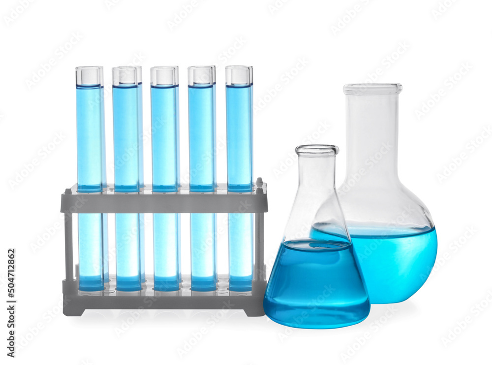 Different laboratory glassware with light blue liquid on white background Different laboratory glassware with light blue liquid on white background