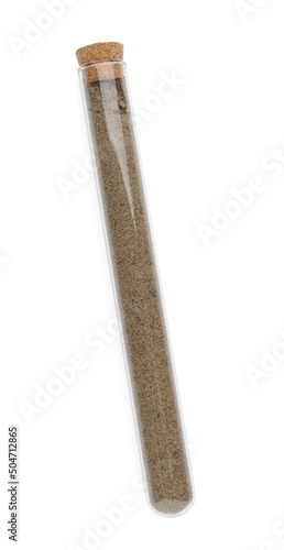Glass tube with ground black pepper on white background, top view