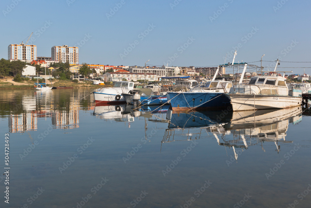 Boats at the pier in the early morning in the Cossack Bay of the city of Sevastopol, Crimea