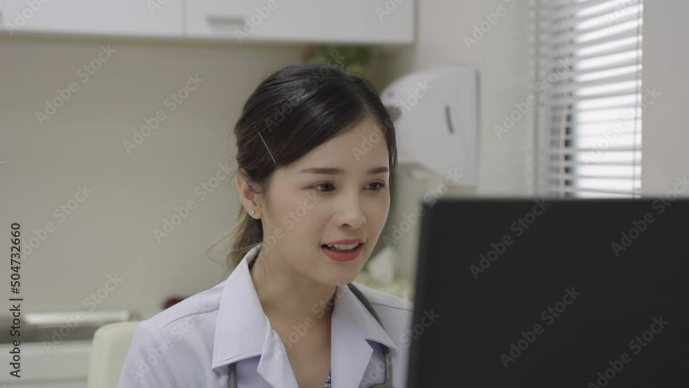 Close-up portrait, Asian female doctor video conference chat with patient discussing and diagnosing and look at monitor. Close-up portrait, Asian female doctor video conference chat with patient discussing and diagnosing and look at monitor.