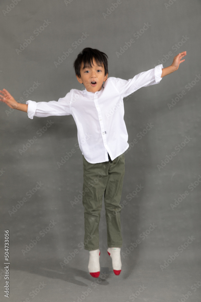 little boy fashion Smiling child in white shirt and gray pants, style and fashion ideas for children.