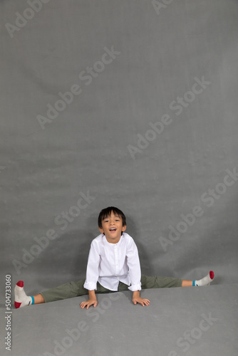 little boy fashion Smiling child in white shirt and gray pants, style and fashion ideas for children.